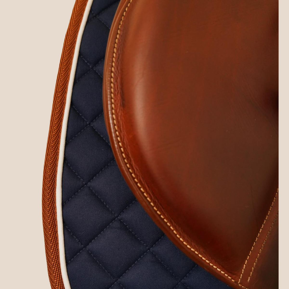 Close-up of the binding on a 16 Cypress Daily Sport navy jumper saddle pad.
