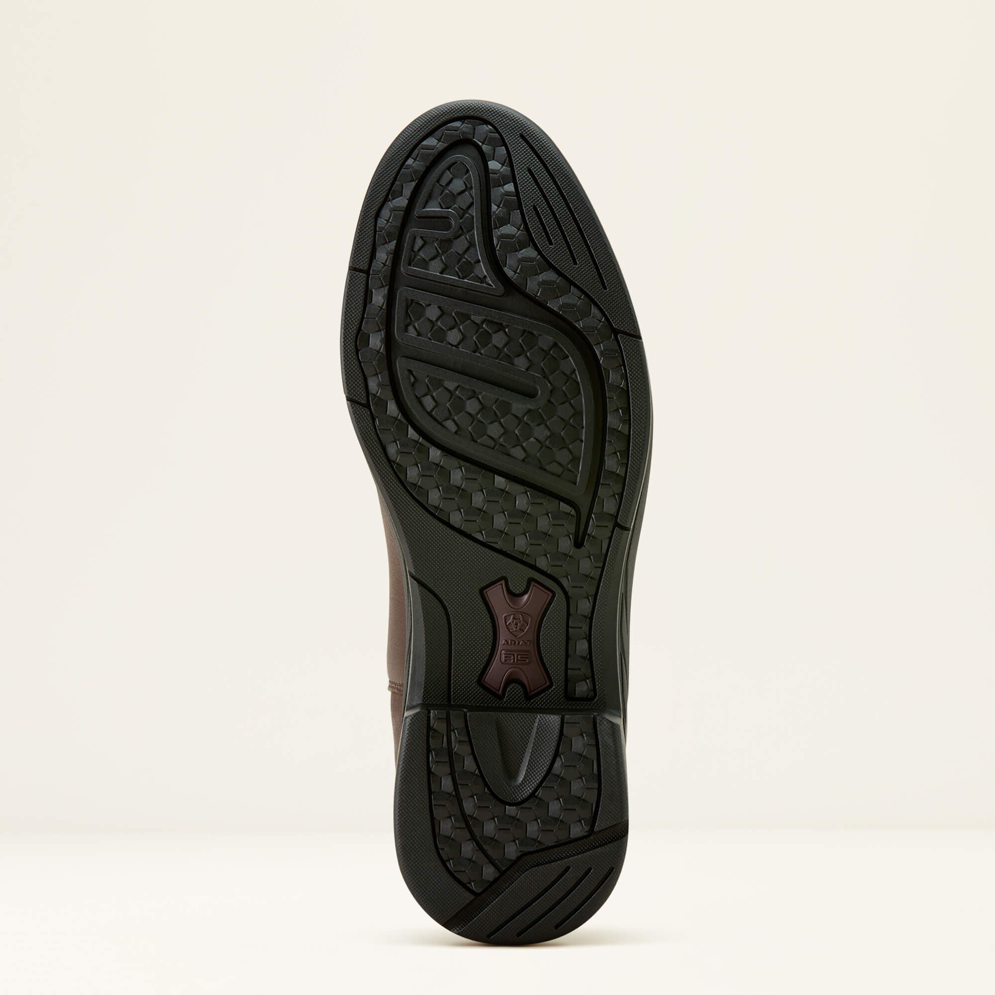 Close-up of the Ariat Stamford Waterproof Boot sole with a brand logo on a beige background