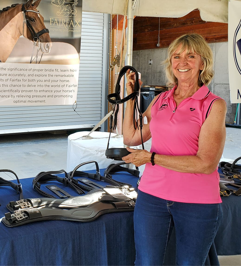 Image of M & M Tack Shop owner Michele Karowski with her Fairfax bridle display.