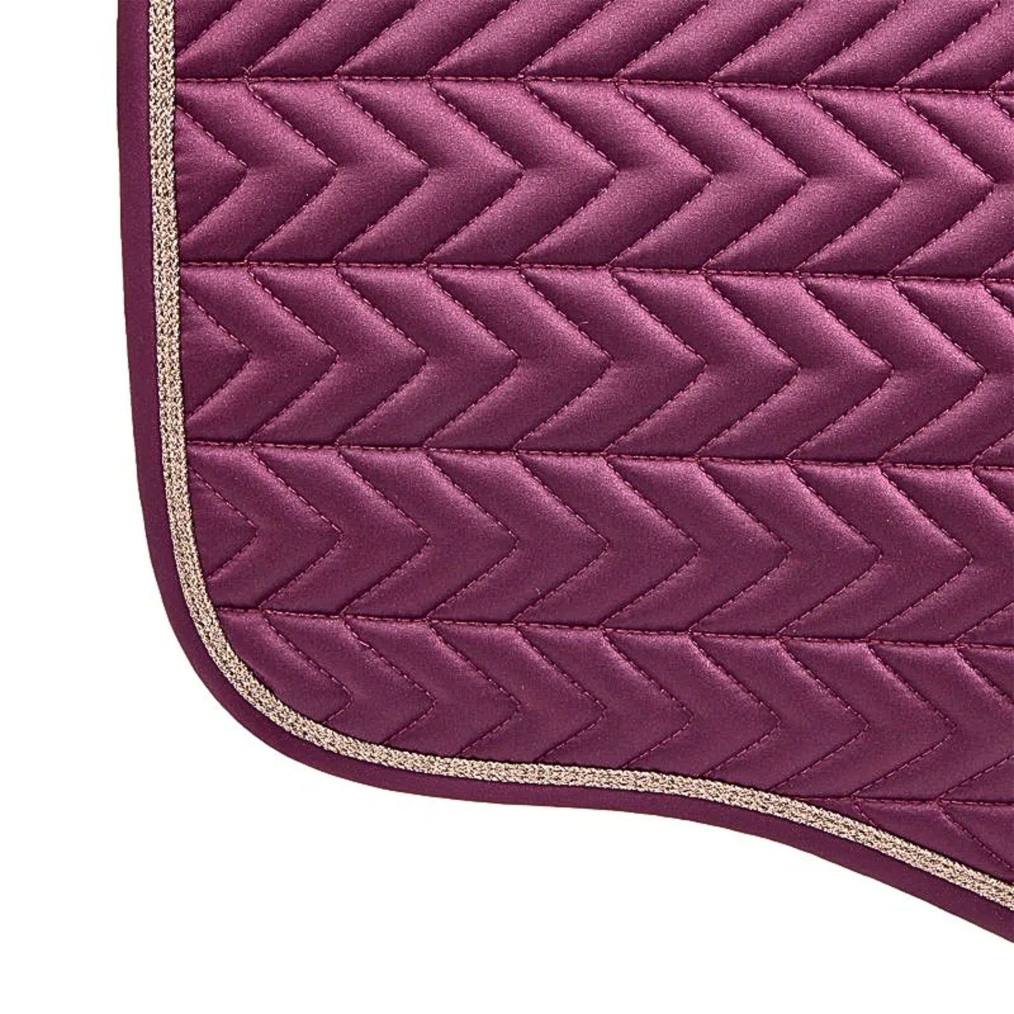 Close-up of a purple quilted saddle pad with a gold edge on a white background