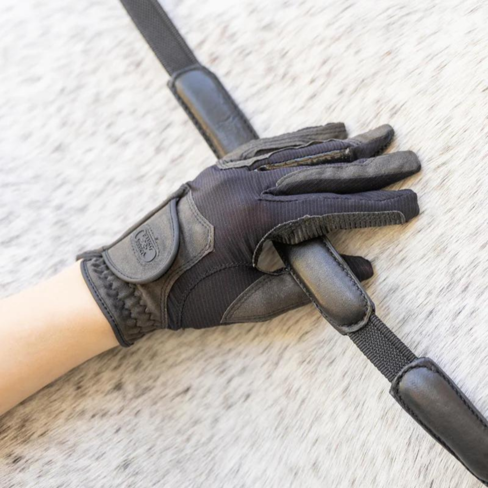 A black pair of correct connect gloves with black reins.