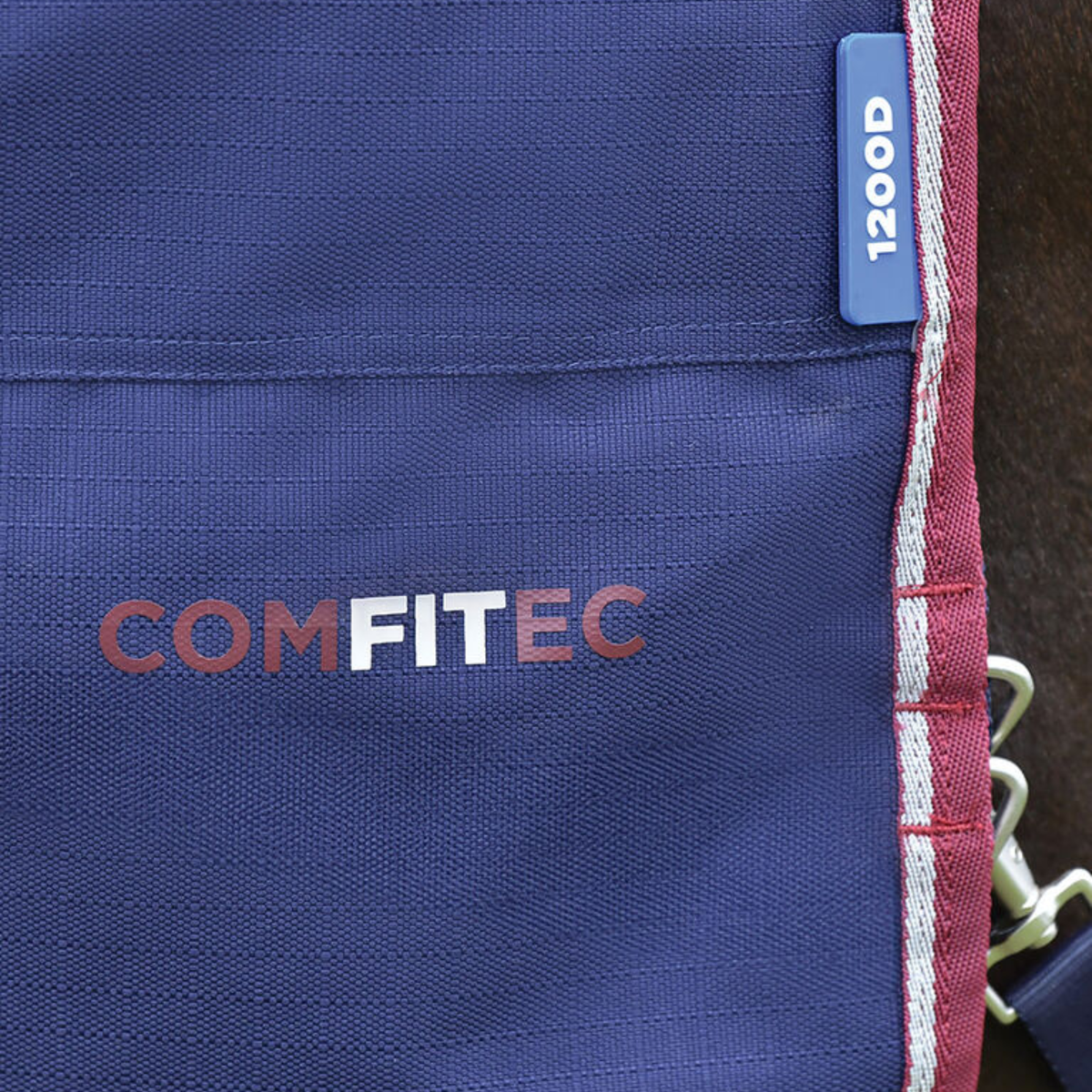 Close up of the logo on Weatherbeeta Comfitec Essential Turnout in Navy/Burgundy.