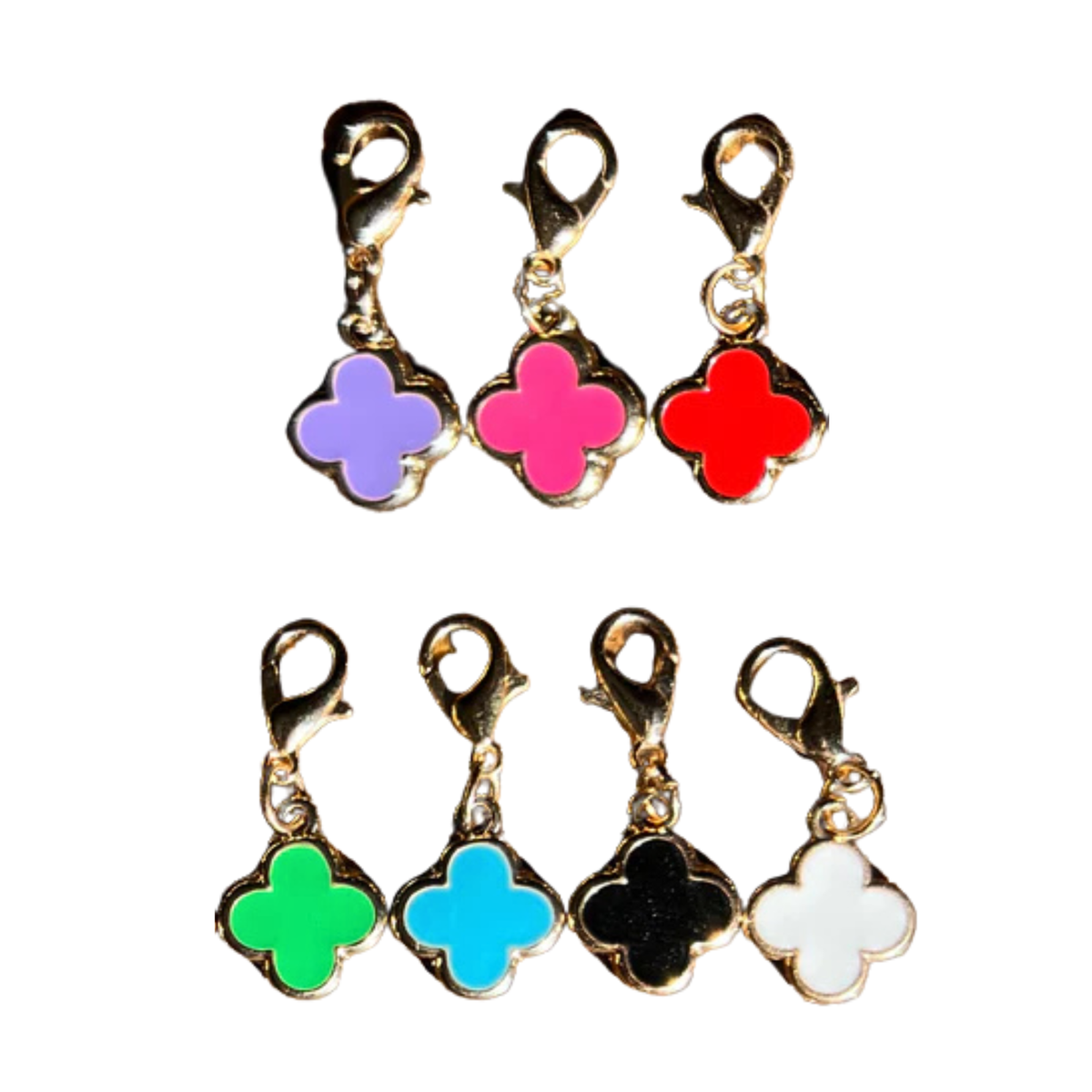 Set of colorful clover-shaped charms with gold loops on a white background
