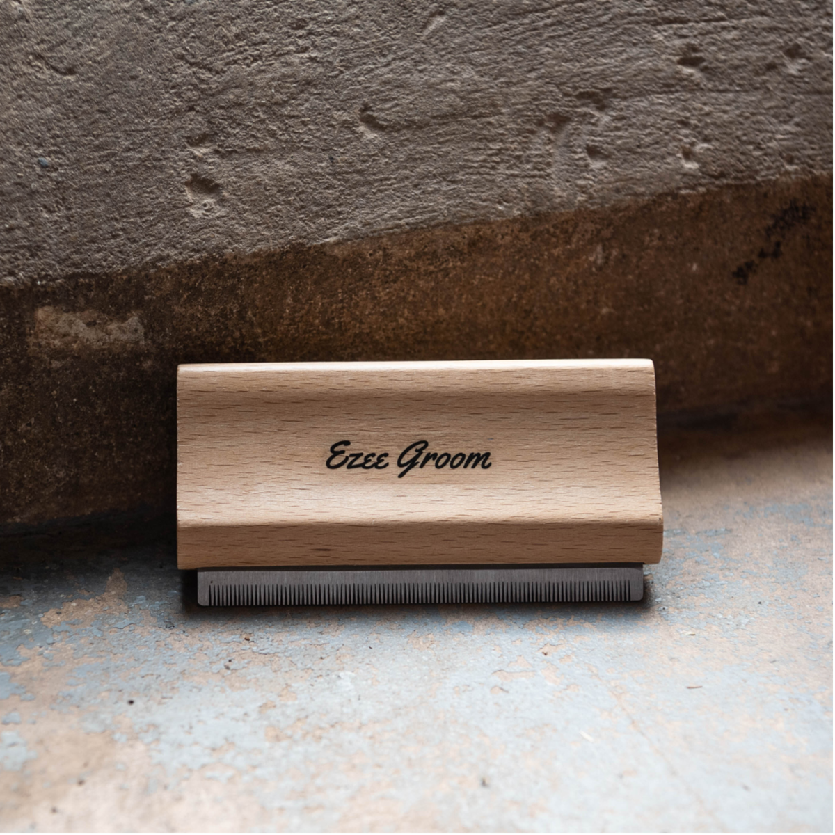A wooden Smart Grooming Ezee Groomer shedding tool with steel teeth, branded &