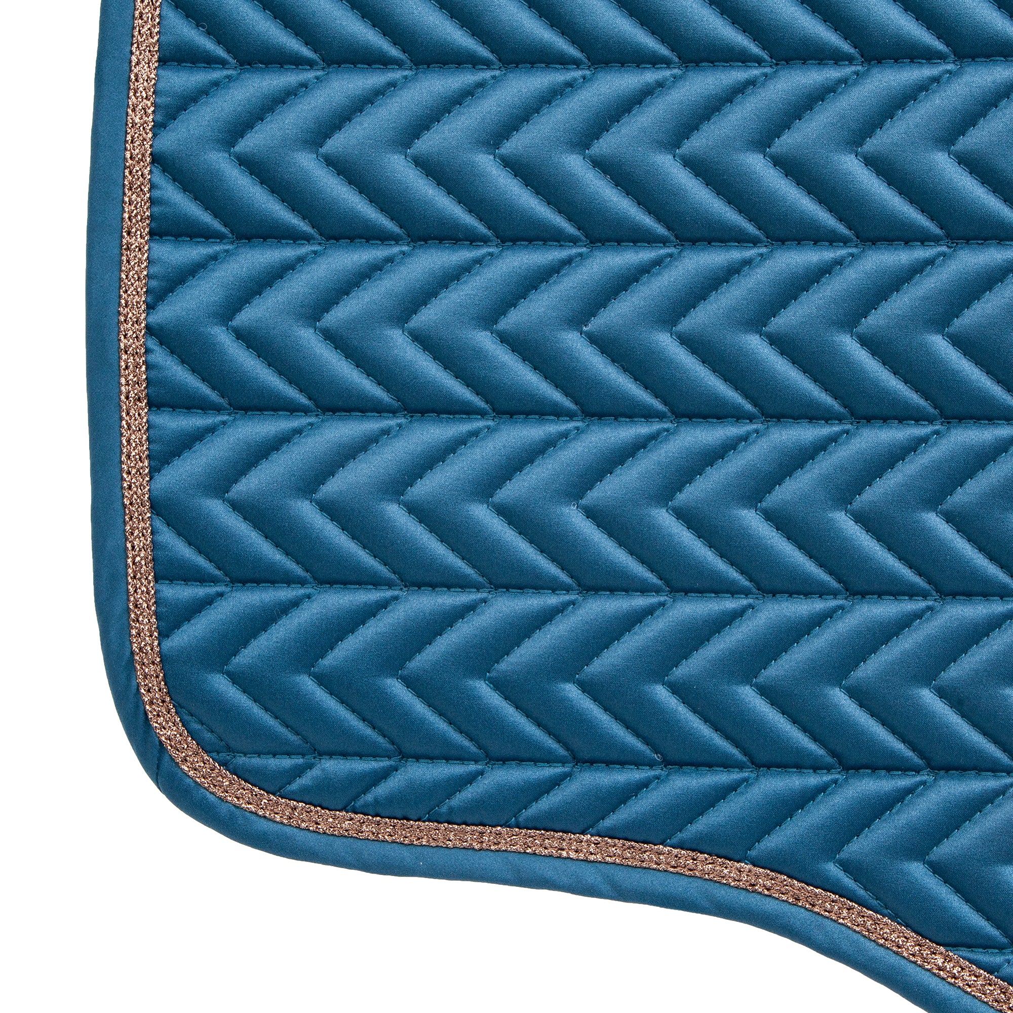 Corner detailing of blue chevron saddle pad. Gold glitter detail along the edges.