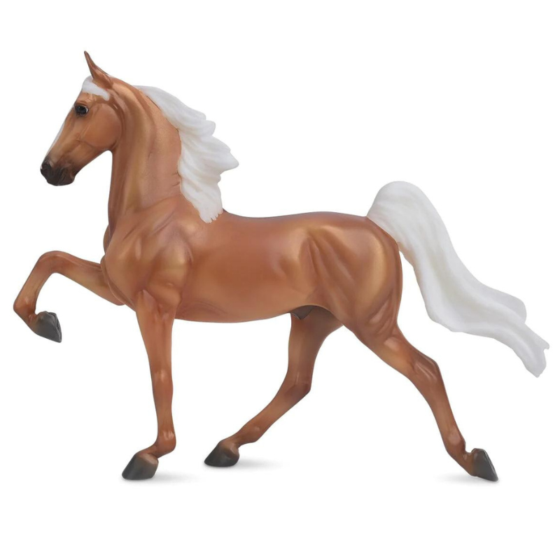 A palomino tennessee walking horse breyer model. Horse has golden body hair with white mane and tail.