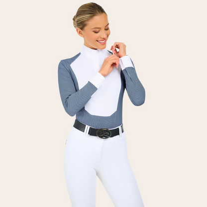 Product image of R.J. Classics blue petal dots Liv show shirt on a model examining the cuff while wearing white breeches and a black R.J. Classics belt. 