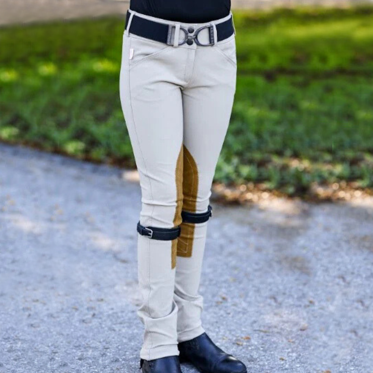 A girl is seen standing wearing Tailored Sportsman Trophy Hunter Jods in Tan.