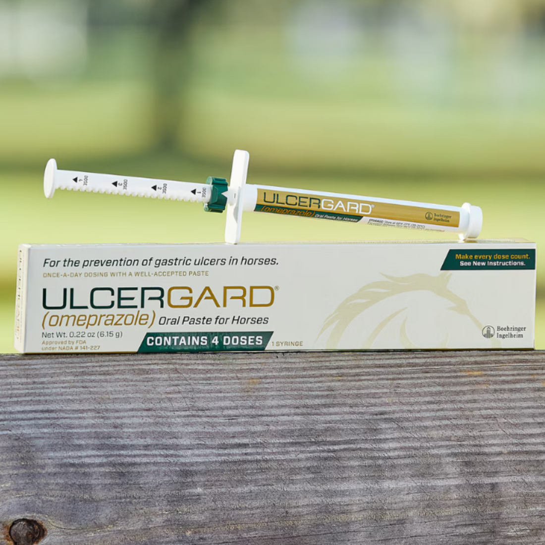 A tube of UlcerGard horse supplement with a syringe, placed in front of its packaging box.