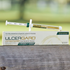 A tube of UlcerGard horse supplement with a syringe, placed in front of its packaging box.