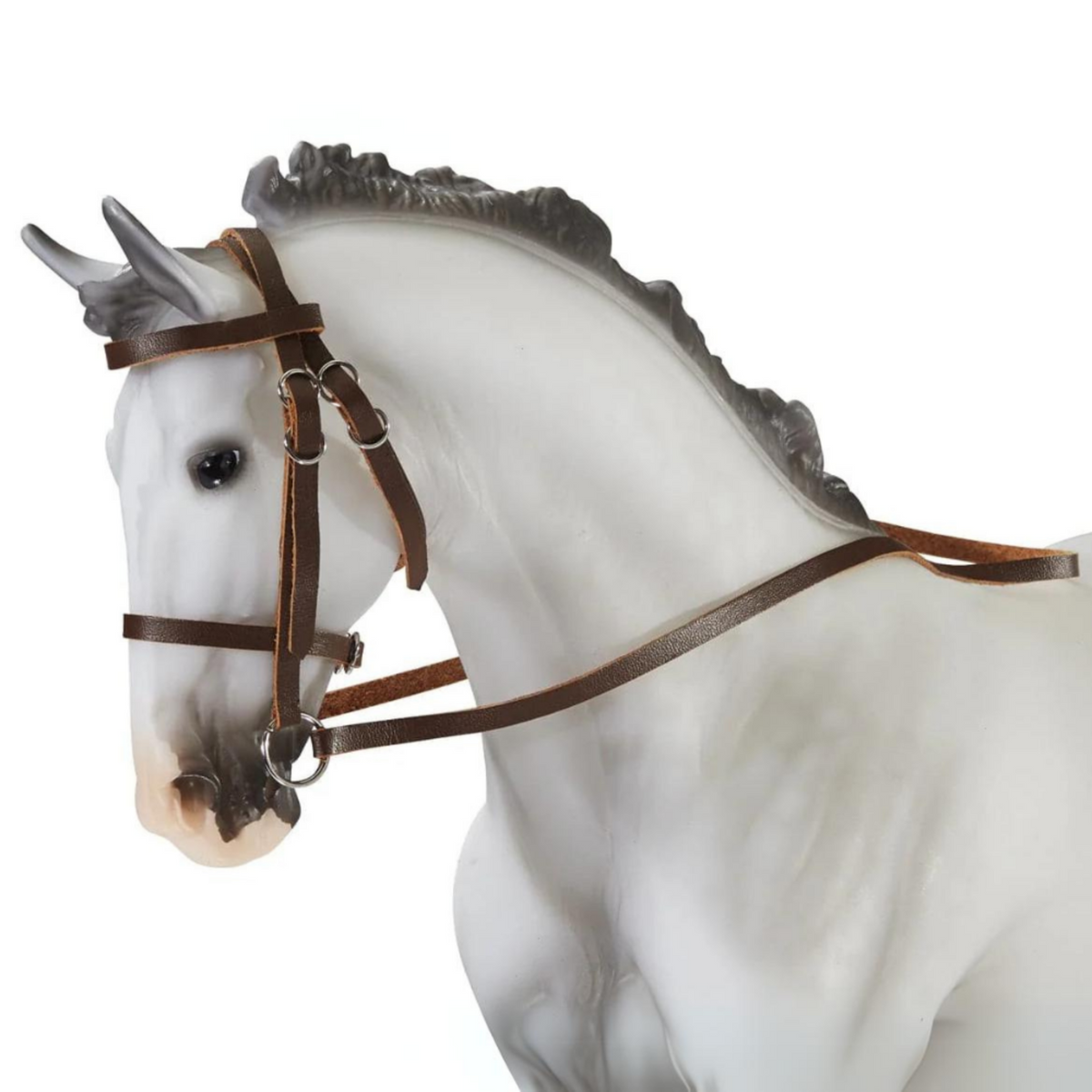A white breyer model horse wearing a brown Devon Hunter/Jumper bridle.