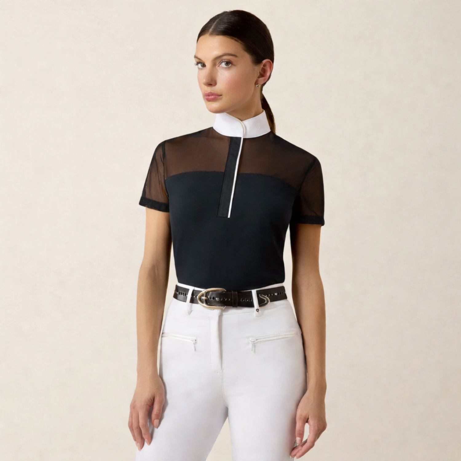 Young woman with dark, pulled back hair wearing an Ariat Allure Short Sleeve Show Shirt with a black bodice and white collar and piping. 