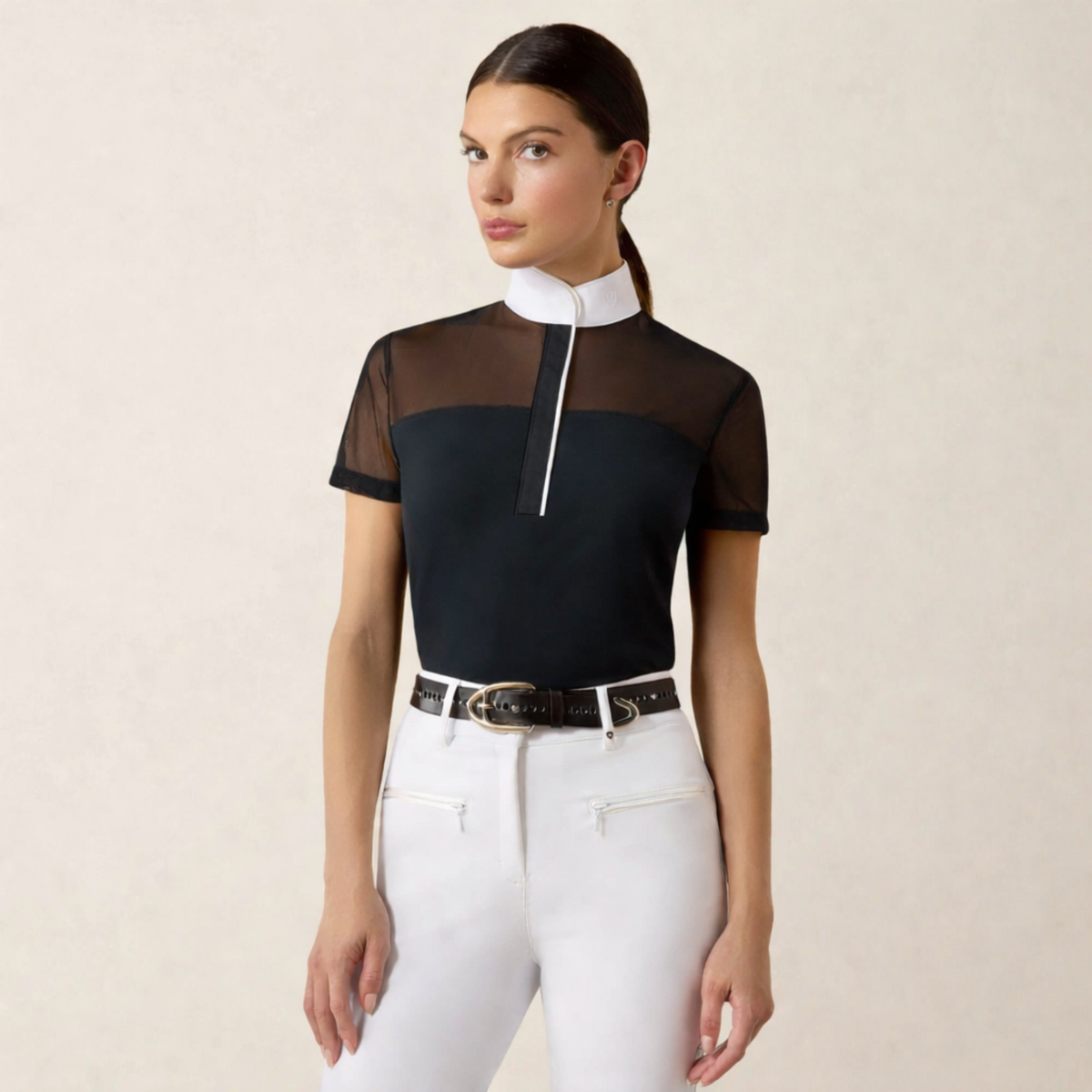 Young woman with dark, pulled back hair wearing an Ariat Allure Short Sleeve Show Shirt with a black bodice and white collar and piping. 