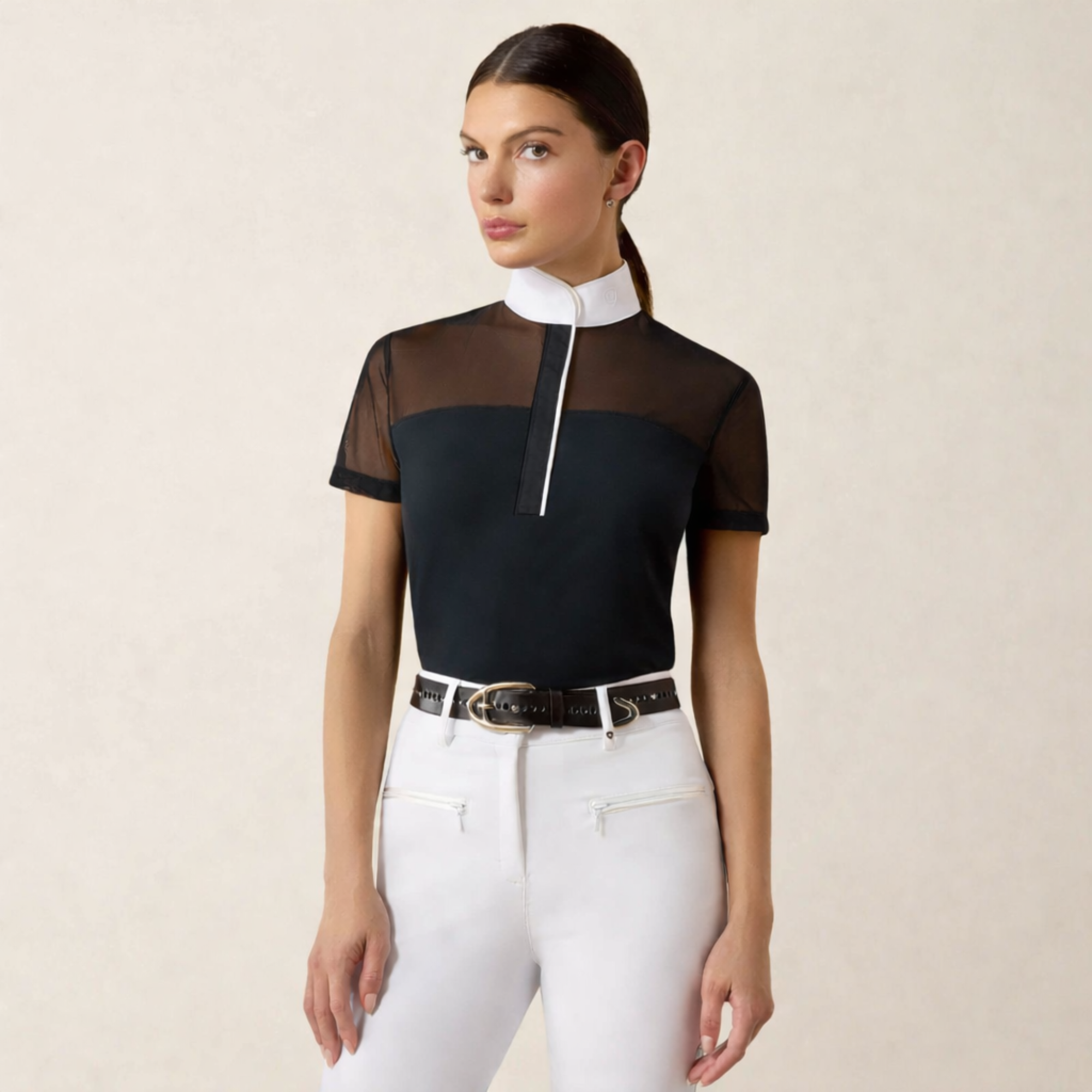 Young woman with dark, pulled back hair wearing an Ariat Allure Short Sleeve Show Shirt with a black bodice and white collar and piping. 