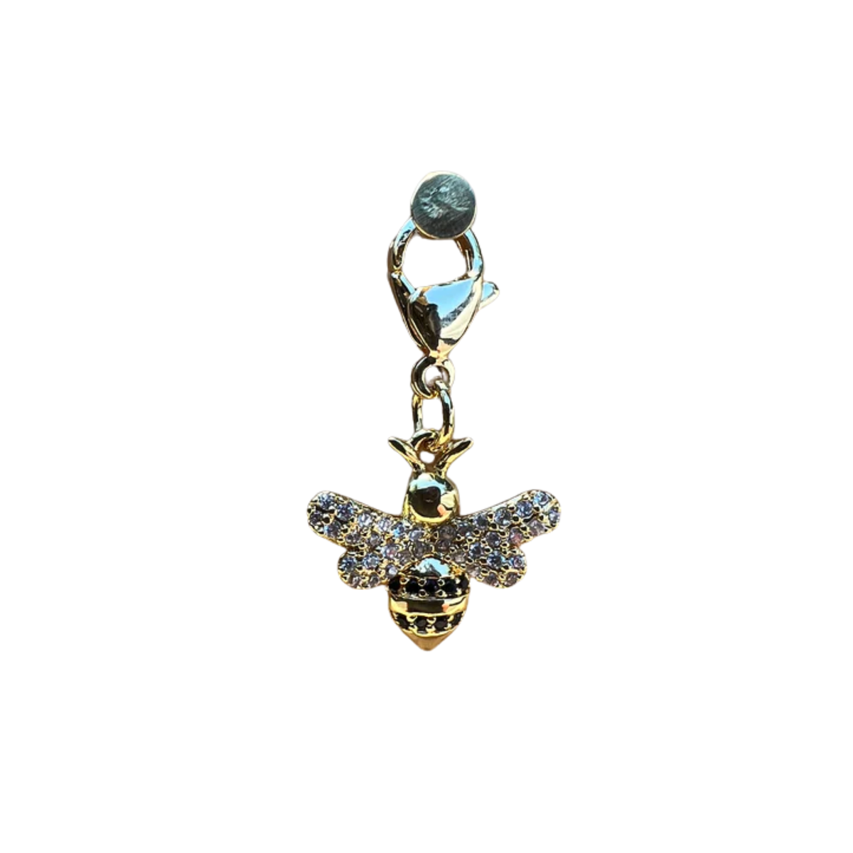 Gold bee charm with gemstones on a white background