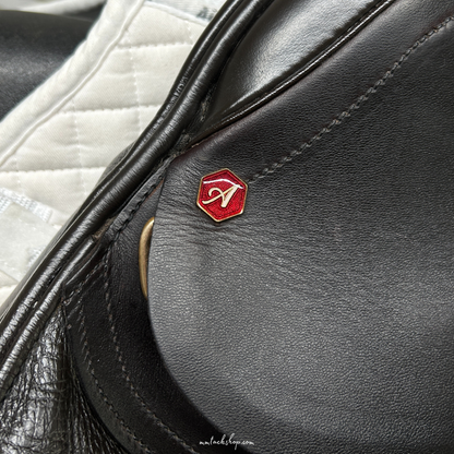 Close up of the near side head pin on a dark Havana demo Albion 17.5" flat forward, medium wide jump saddle. 