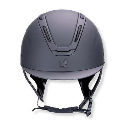 A matte matte black Karben Amity SMRT equestrian riding helmet with a Karben logo on the front, black chin strap, and ventilation slots, shown against a plain white background.