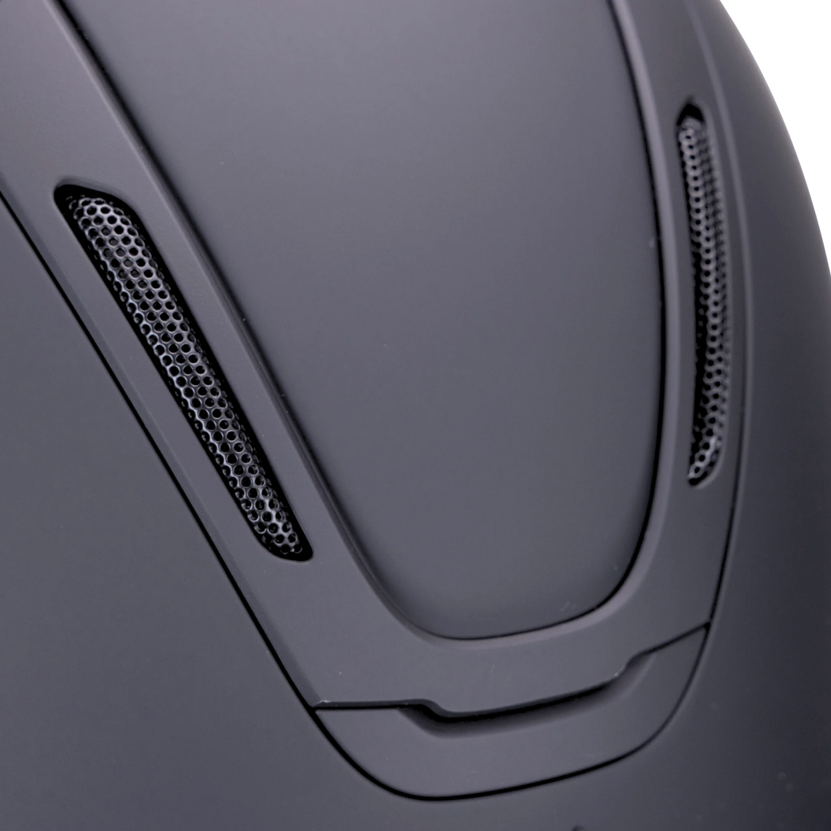 Close-up of  the crown of a matte black Karben eAvmity SMRT riding helmet with two vented side slots and a smooth curved shell design.