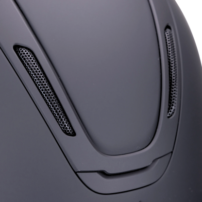 Close-up of  the crown of a matte black Karben eAvmity SMRT riding helmet with two vented side slots and a smooth curved shell design.