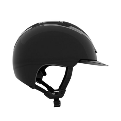 Profile of a shiny KASK black Dogma Pure Shine equestrian riding helmet with chinstrap on a white background.