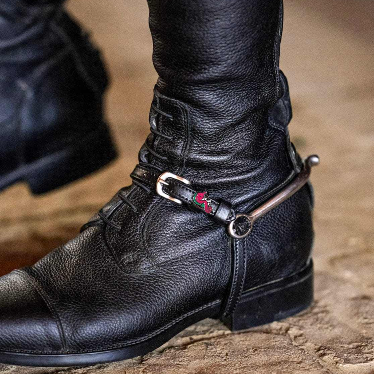 Mane Jane Seahorse charm spur straps on an equestrian riding boot.