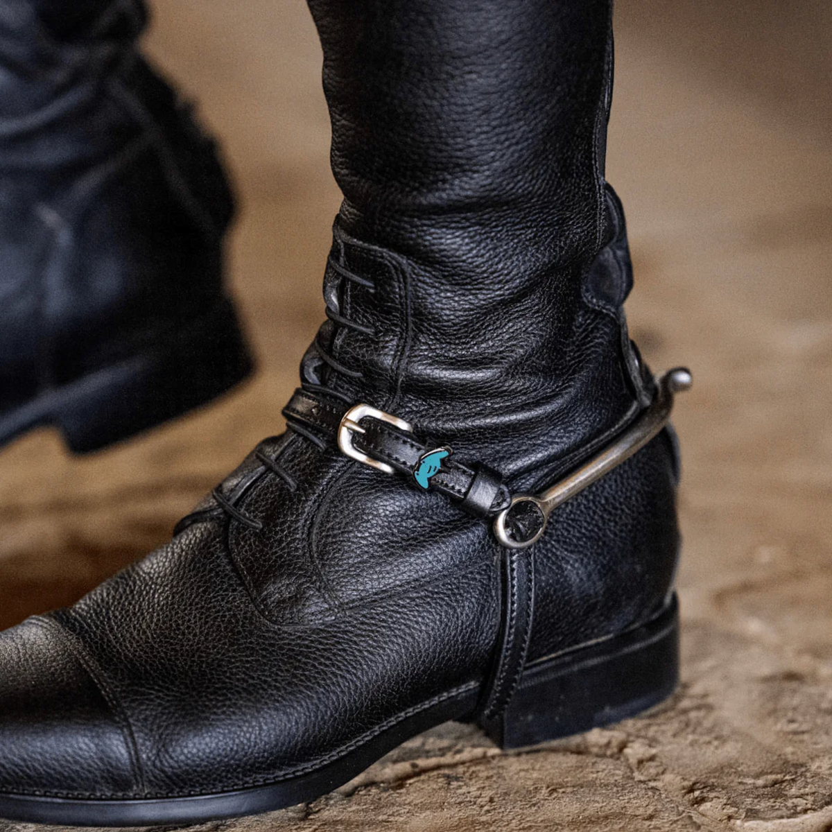 ManeJane Stingray charm spur straps on a riding boot.