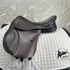 Thorowgood T9 Pony saddle on a white quilted saddle pad with a patterned gray background.