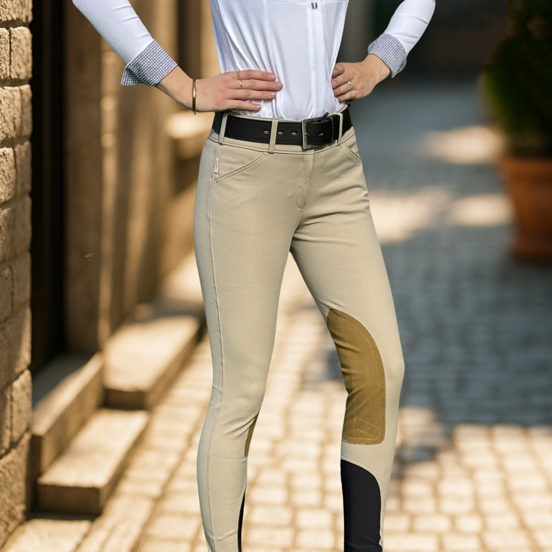 An Equestrian wearing Tailored Sportsman Trophy Hunter Low Rise Front Zip Boot Sock Breech in Tan.