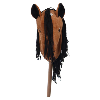 A brown horse head toy with a black faux-fur mane and black ears, mounted on a wooden stick, shown against a plain white background.