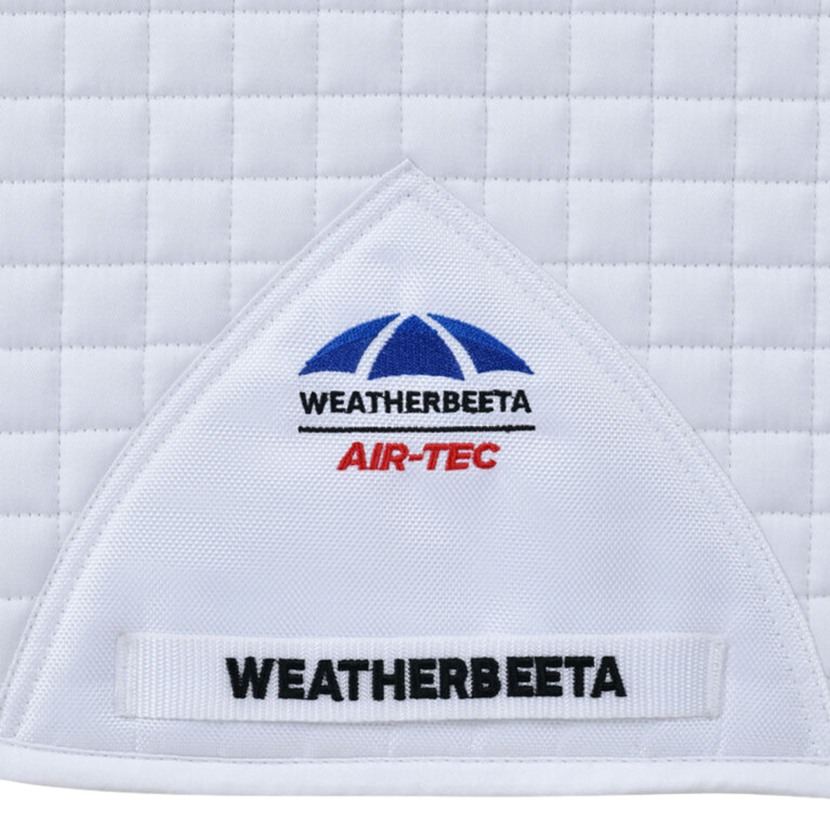 A close up of the Weatherbeeta logo on the Air Tec Dressage Pad in White.