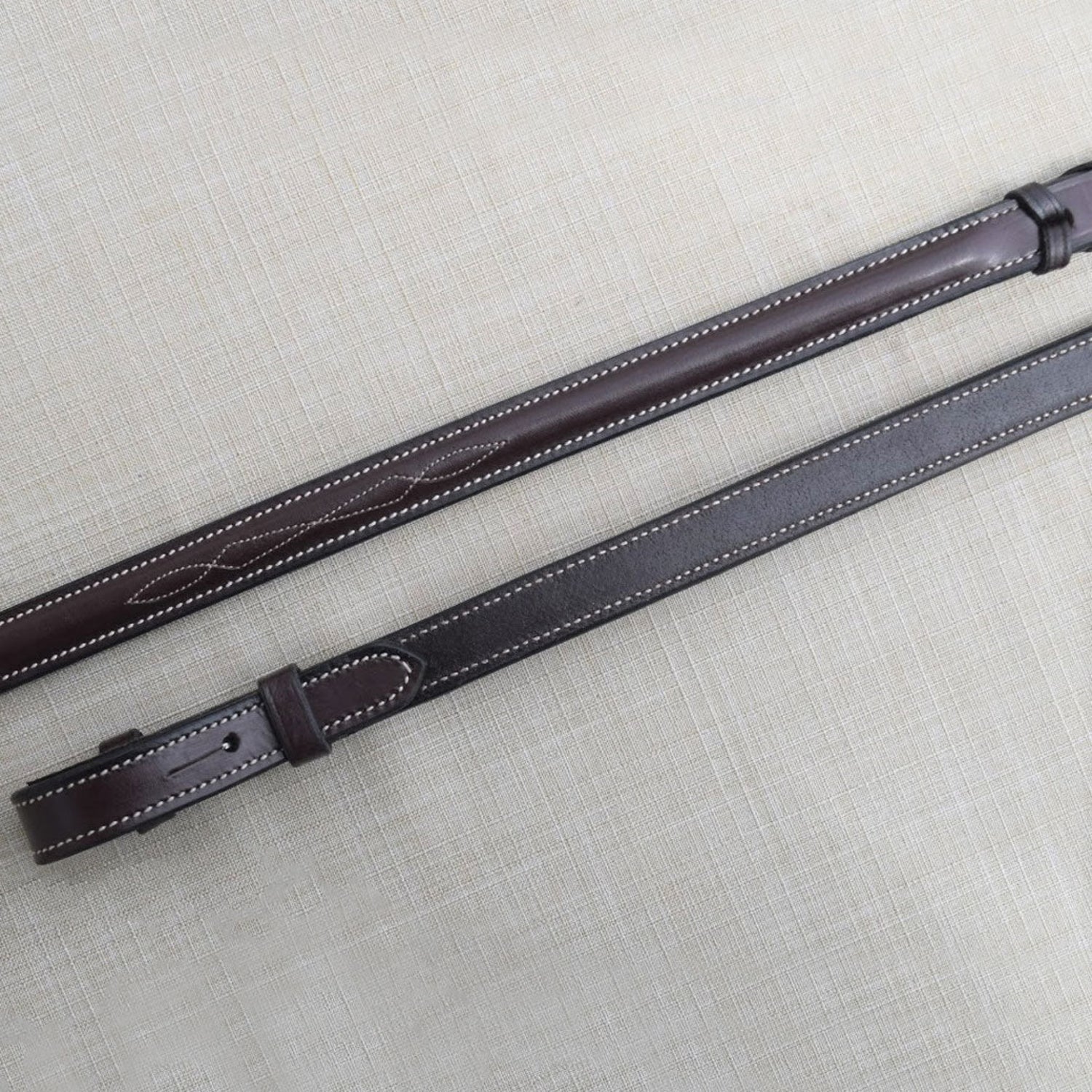 Black Oak Round Raised reins close up of fancy stitch.