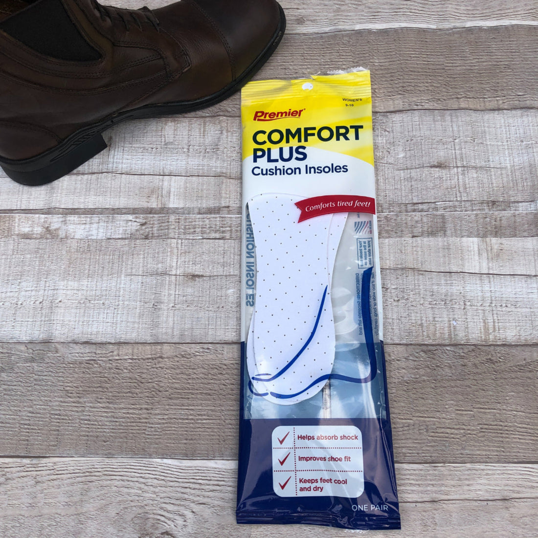 A pair of foam insoles packaged in a plastic sleeve with the brand name &