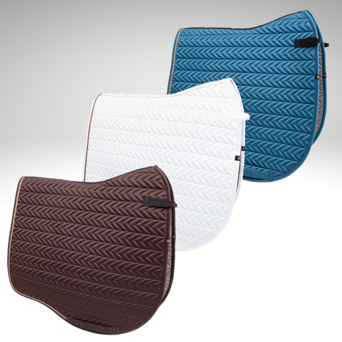 Three Tango Chevron Dressage Pads in different colors: white with blue chevron quilt pattern, blue with white chevron quilt pattern, and brown with brown chevron quilt pattern.
